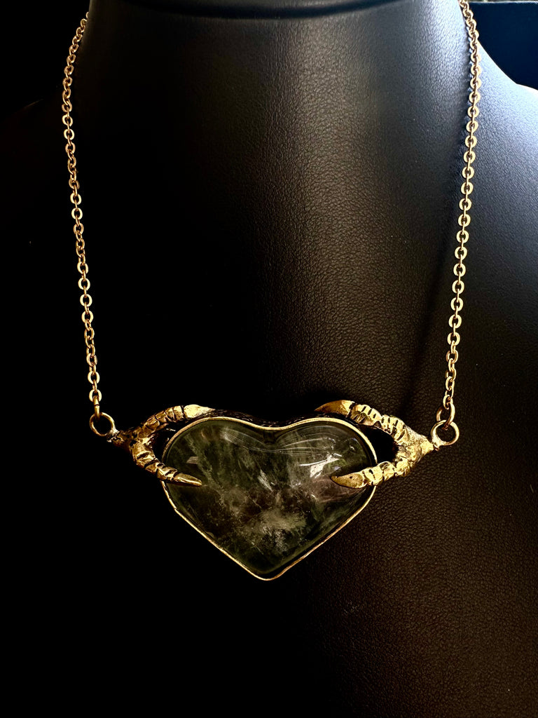 Crow Claw holding Rutilated quartz Heart