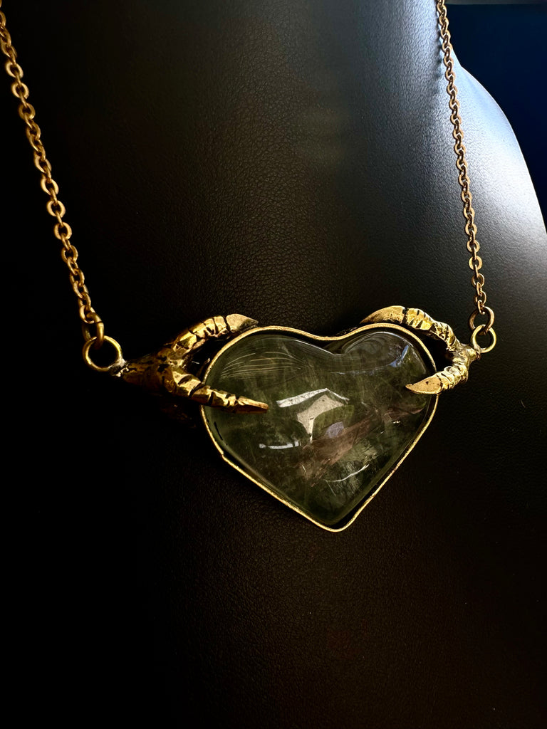 Crow Claw holding Rutilated quartz Heart