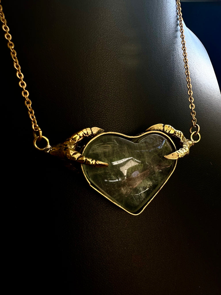 Crow Claw holding Rutilated quartz Heart